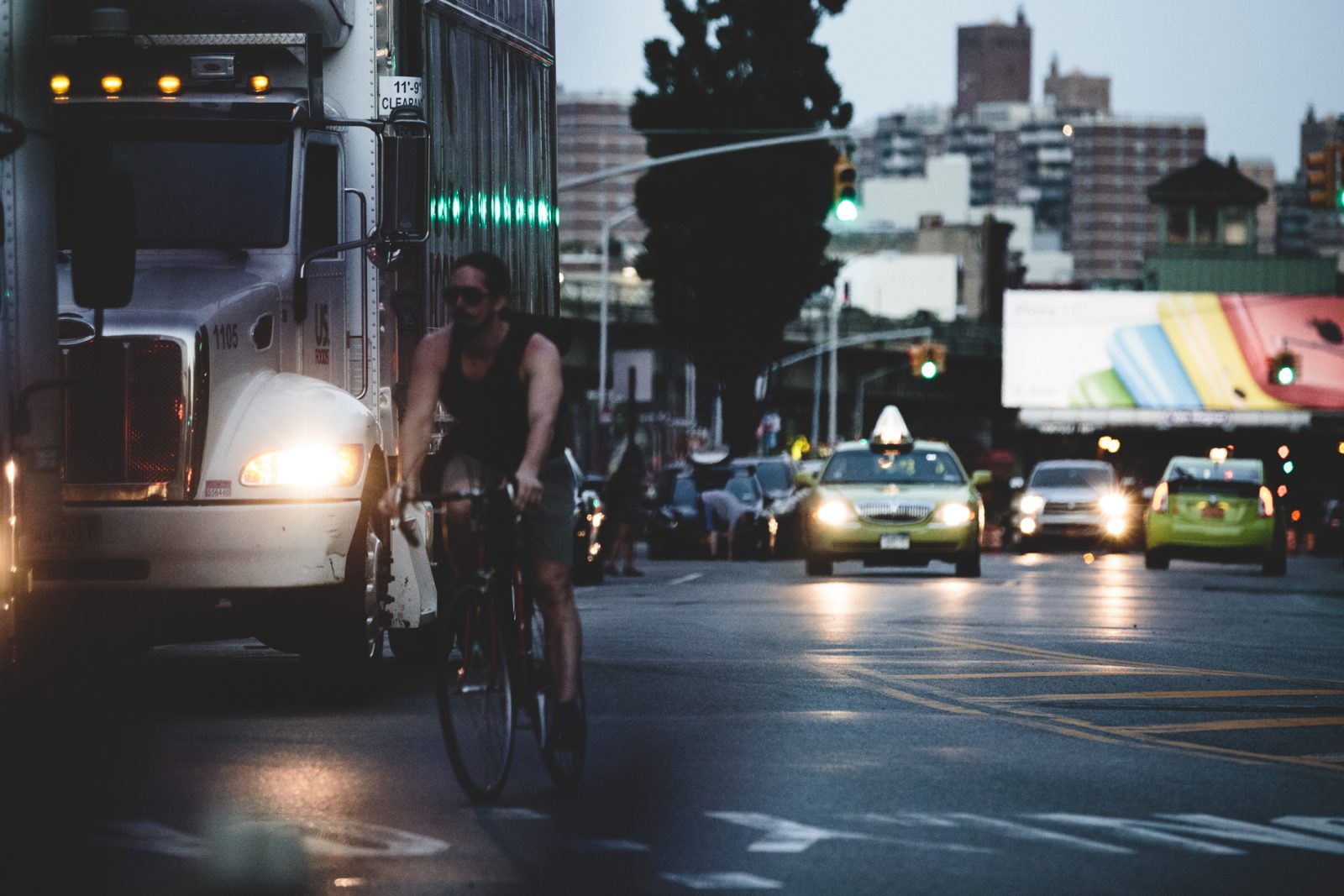 man riding bike on busy street