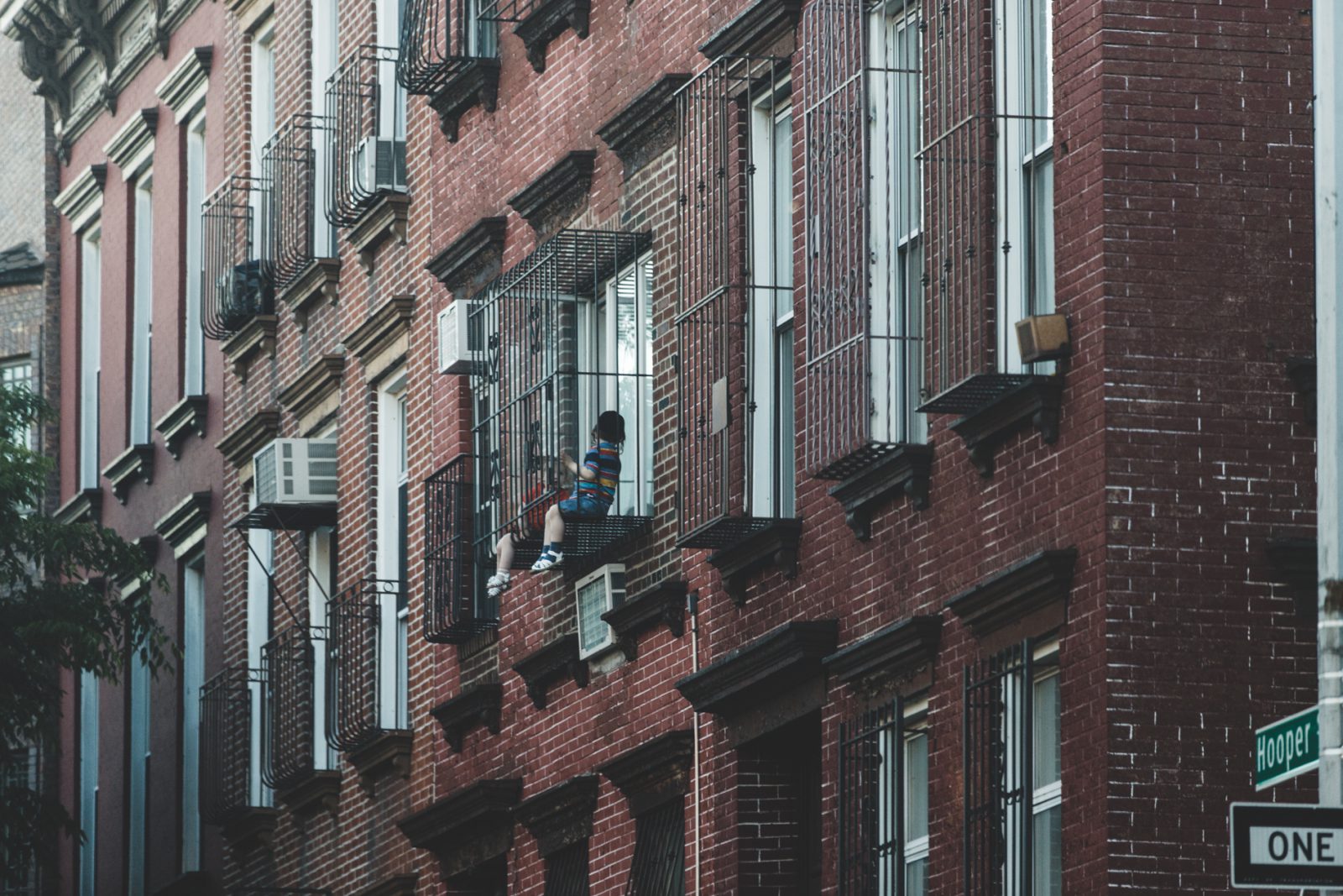kid sitting on fire escape