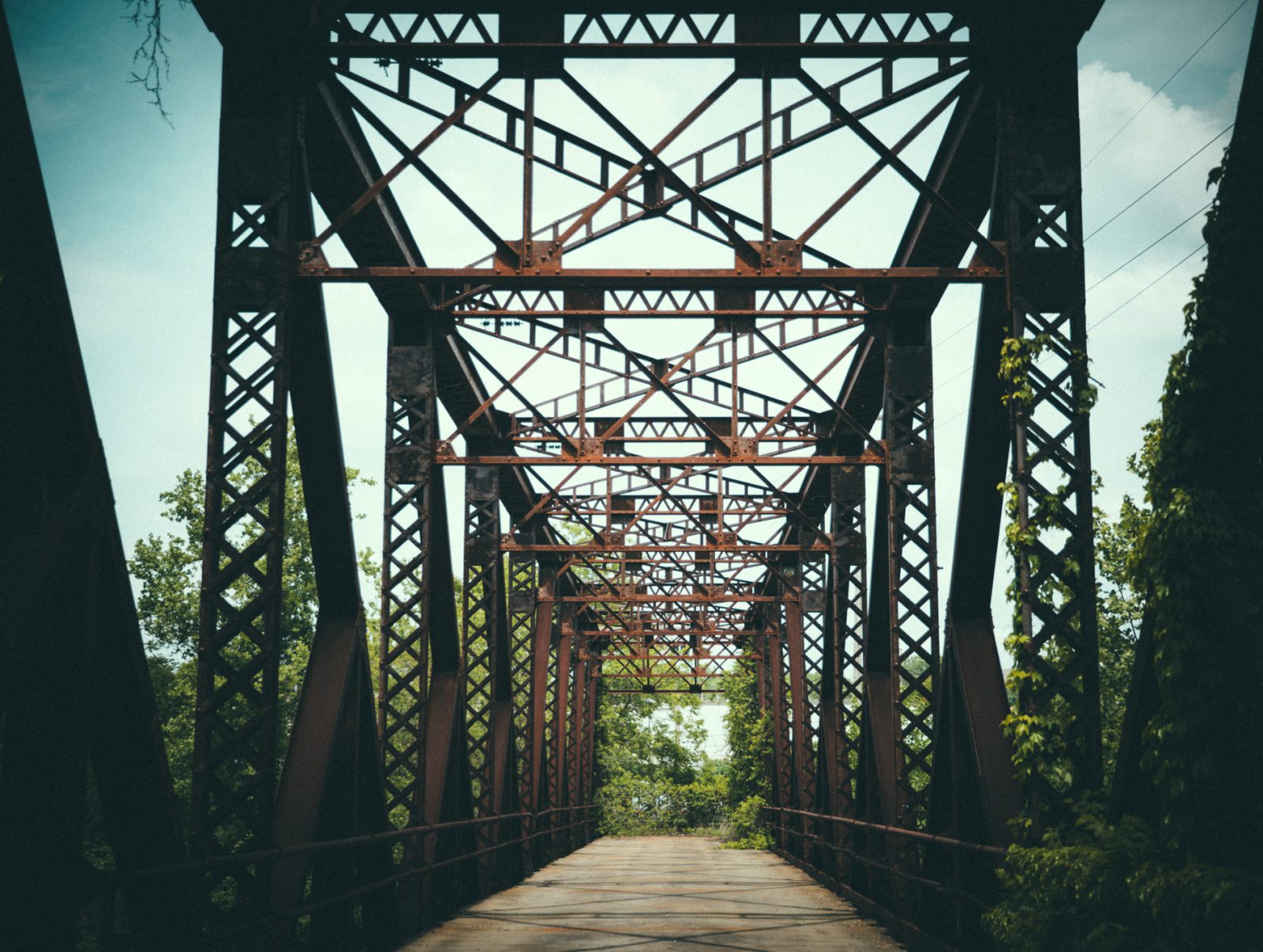 rusted metal bridge overgrown