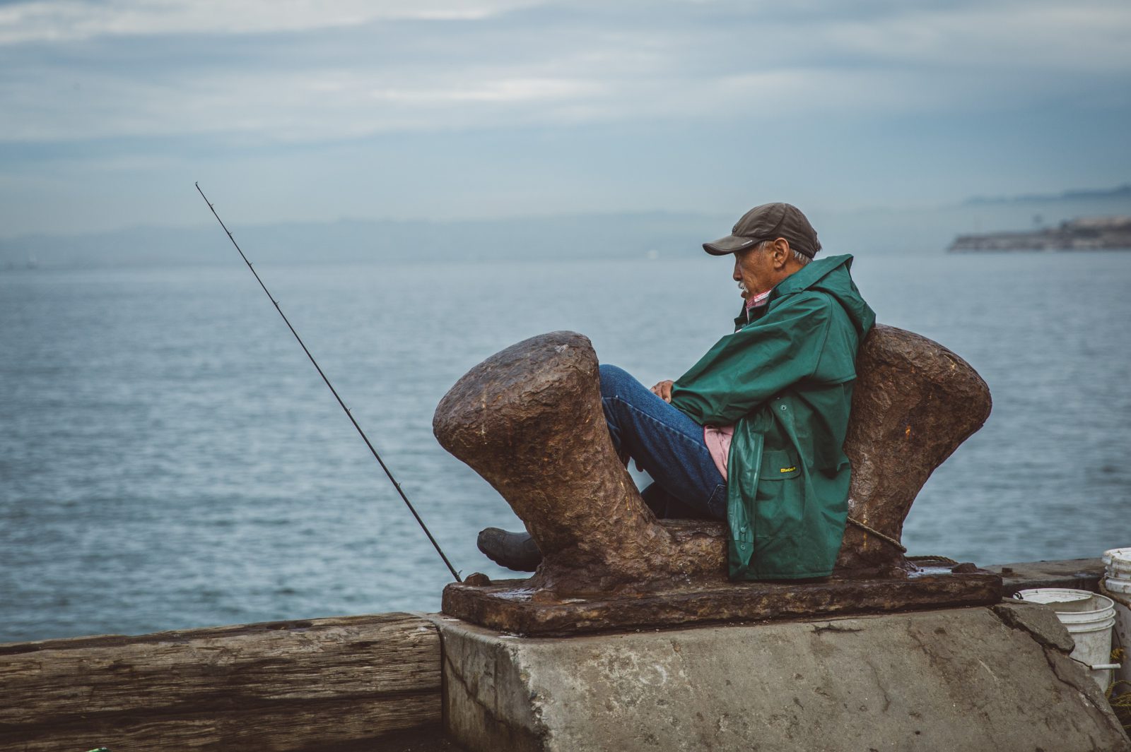 man sitting on pier