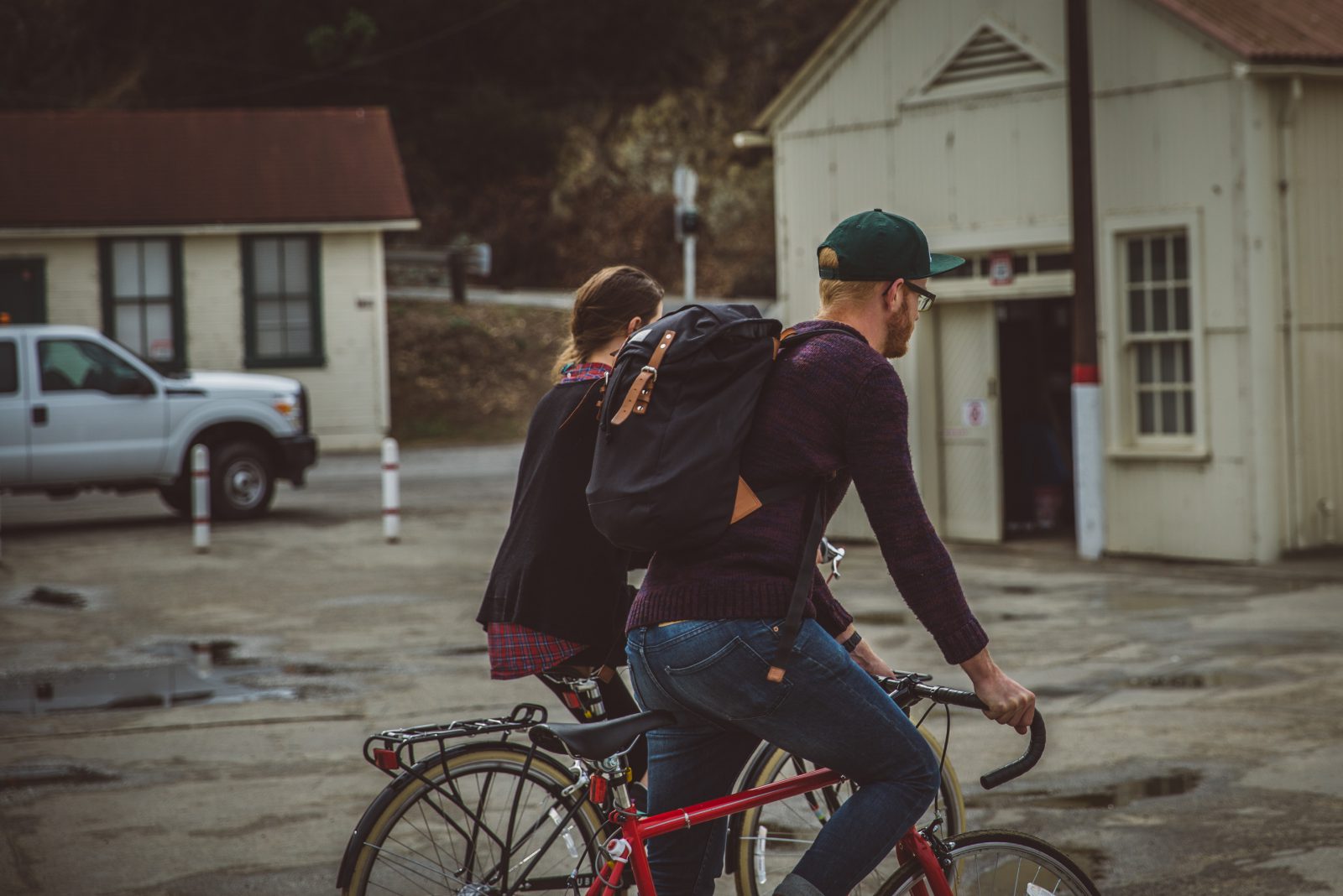 guy and girl riding bikes on pier